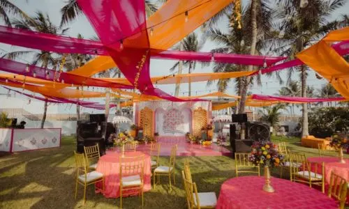 Luxury Mehendi lounge seating décor at Grand Mantram Resort in Gurgaon with vibrant drapes and traditional accents