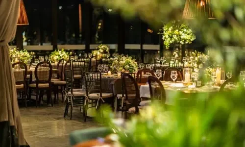 Green lawn and poolside area at Grand Mantram Resort in Gurgaon with dinner seating arrangement for weddings and events