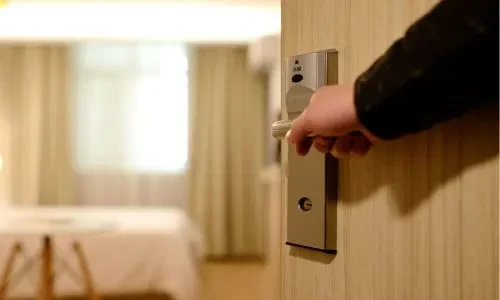 Guest entering a luxury room at Grand Mantram Resort in Gurgaon, showcasing elegant accommodation and modern amenities