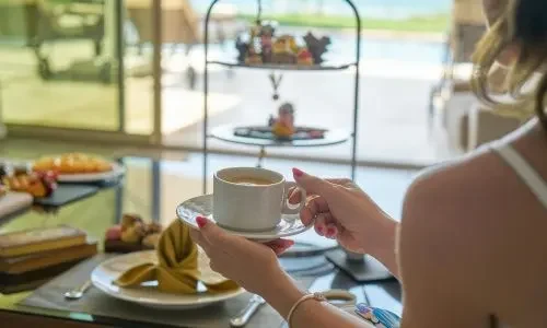 Guest enjoying coffee at Grand Mantram Resort in Gurgaon showcasing recreational facilities and leisure amenities